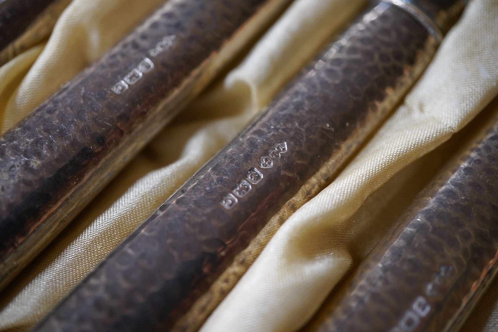 A cased set of six Edwardian silver handled pastry forks by Liberty & Co, with later? steel tines, Birmingham, 1902, 14.8cm, in Liberty & Co box. Condition - fair